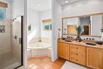 En-suite bathroom with tub, shower, and steam room